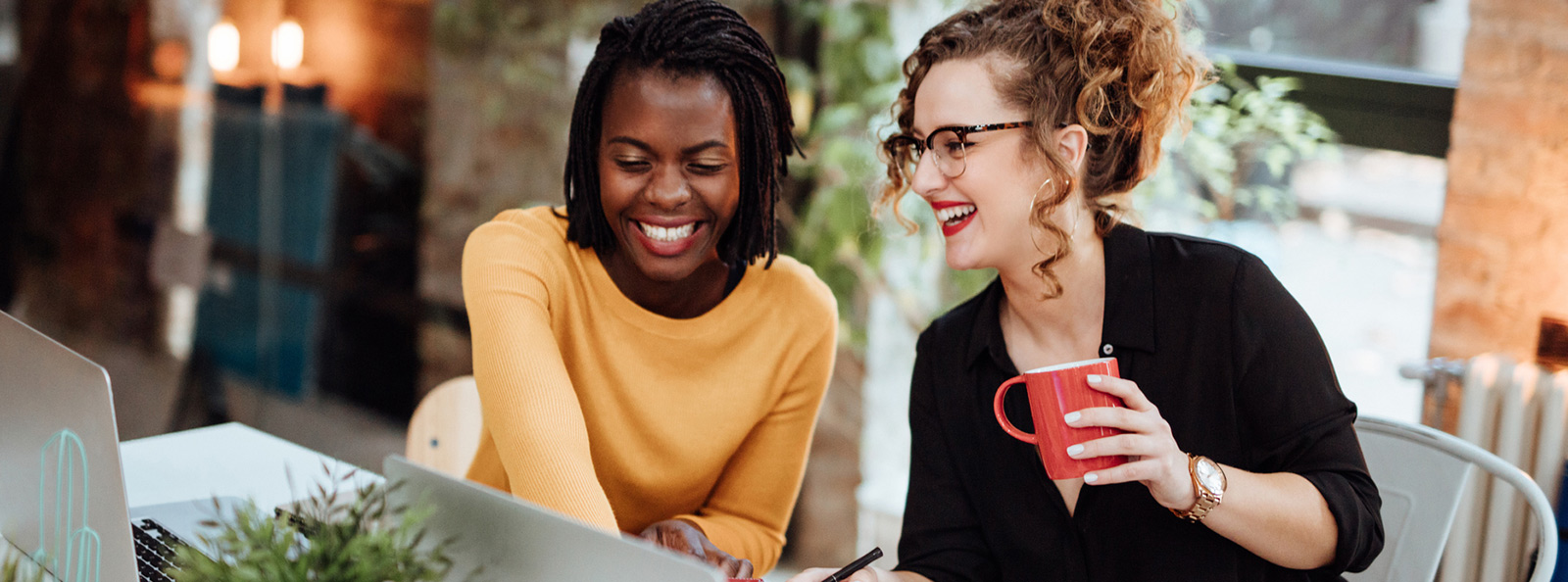 two female coworkers smiling