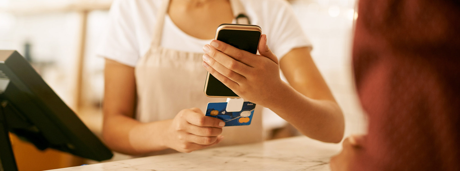 Woman worker swiping card with mobile reader.