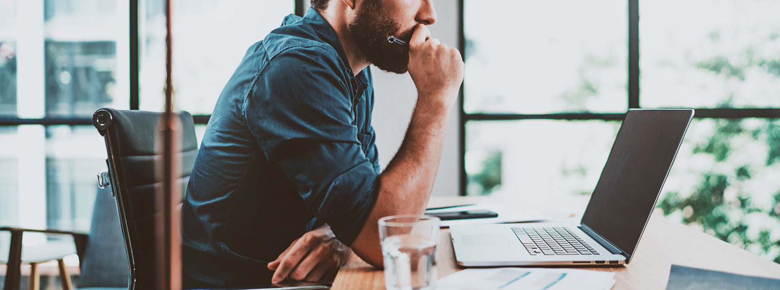 a man sitting looking at his laptop