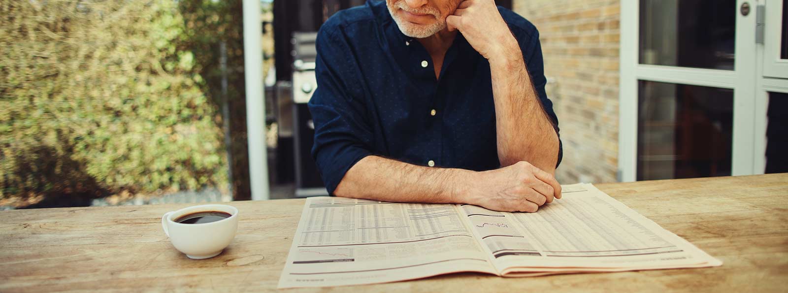 Man looking at newspaper.