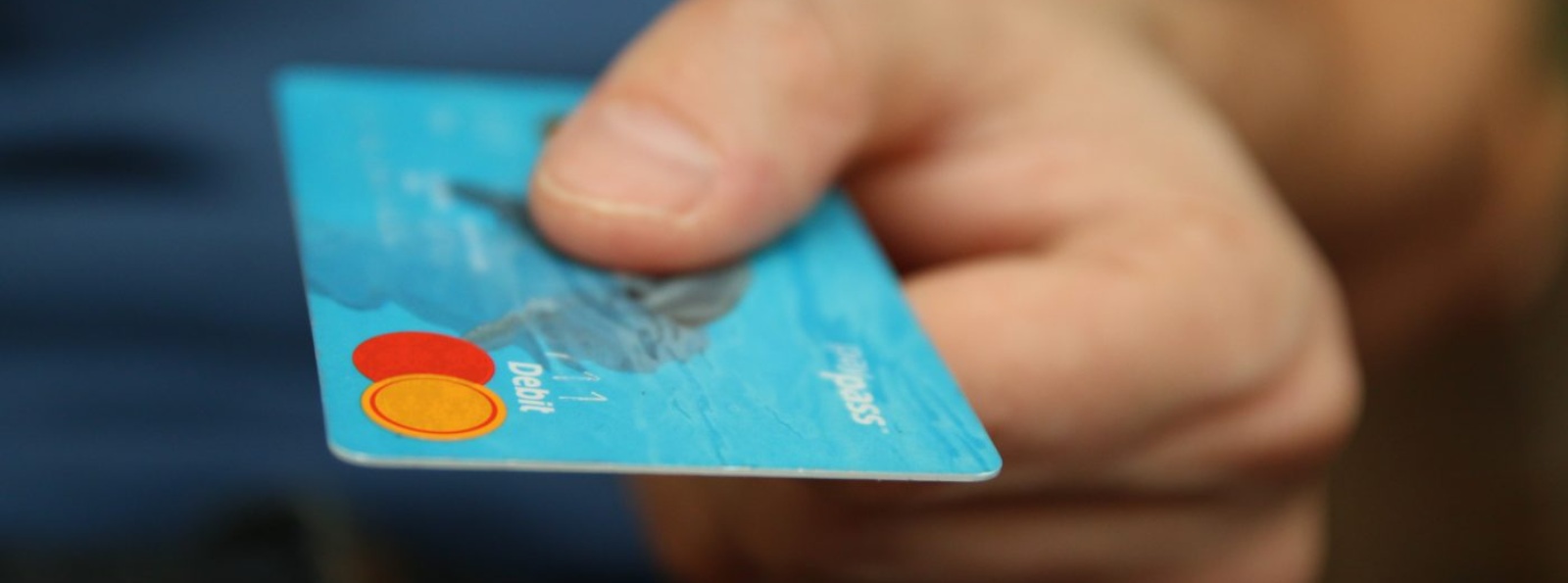 a hand holding a credit or debit card